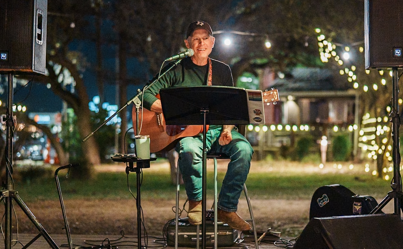 Robin Harrison performing live with acoustic guitar